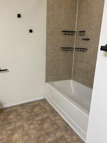 a bath tub sitting next to a white sink