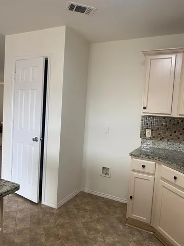 a view of a storage and utility room with closet