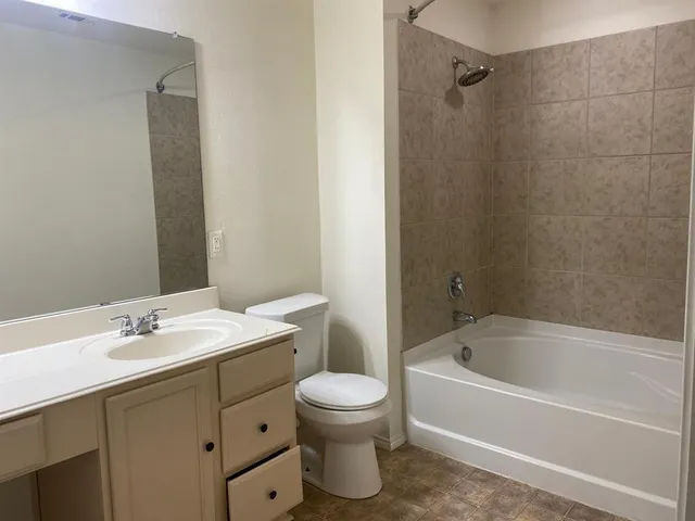a bathroom with a sink toilet tub and shower
