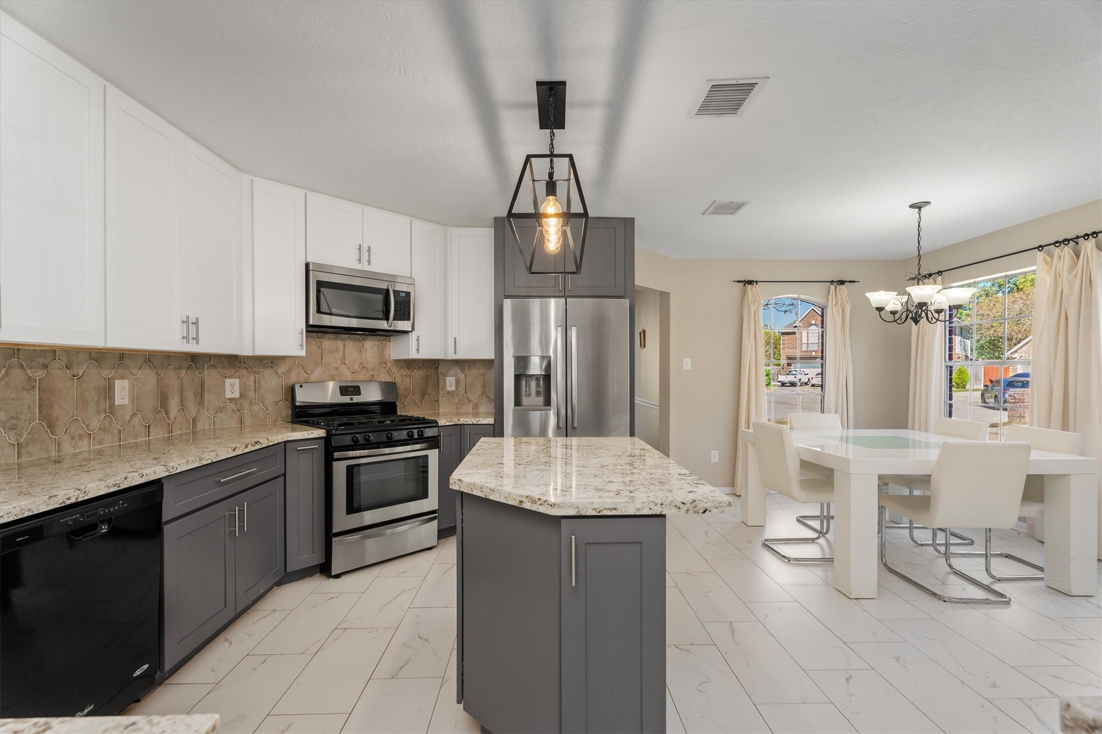 3315 La Seine Lane Spring, TX 77388 - Photo 13 of 31 a kitchen with stainless steel appliances granite countertop a sink dishwasher stove top oven and cabinets