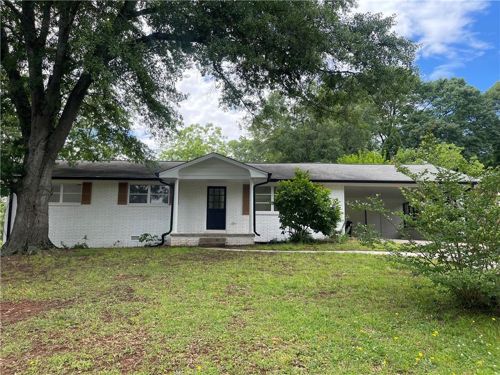 a front view of house with yard and green space