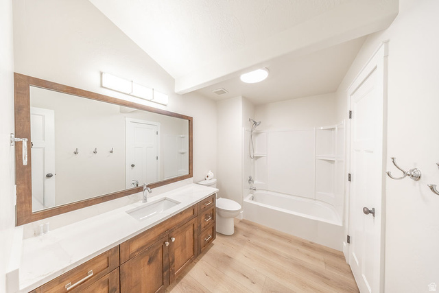 2169 Orchard Pines Loop East Bountiful, UT 84010 - Photo 21 of 32 Spacious bathroom featuring a single vanity with wood cabinetry, white countertop, and a large framed mirror