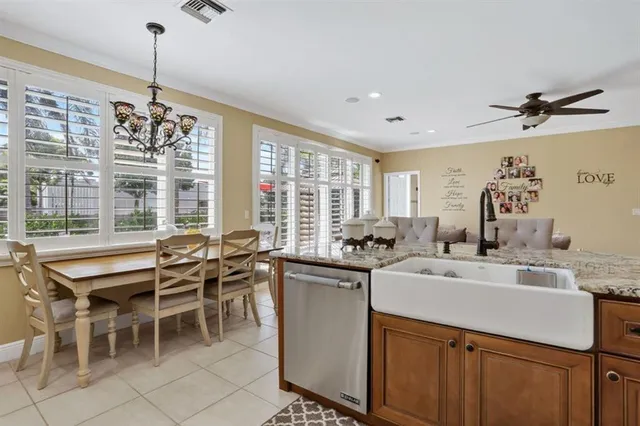 a living room with furniture ceiling fan and a flat screen tv