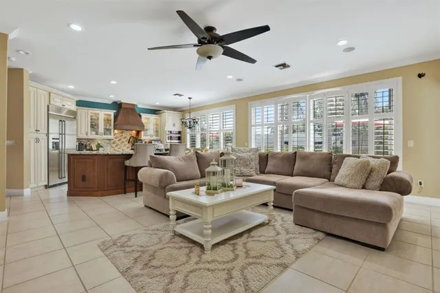 a living room with furniture and a ceiling fan