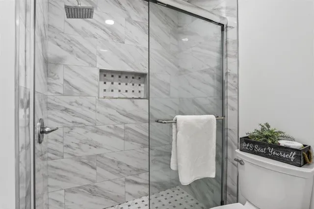 a view of a chair and table in the patio in front of a house