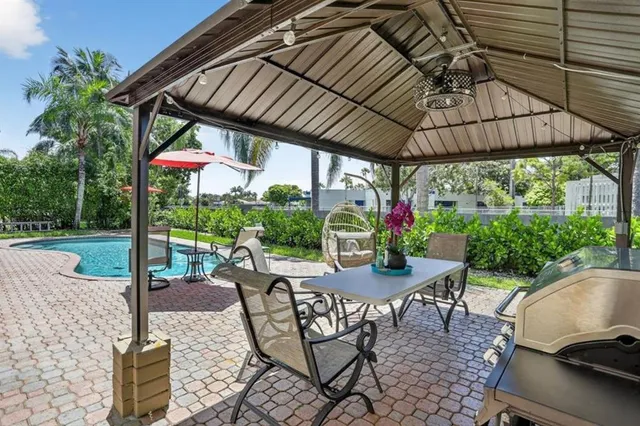 a aerial view of a house with a yard table and chairs