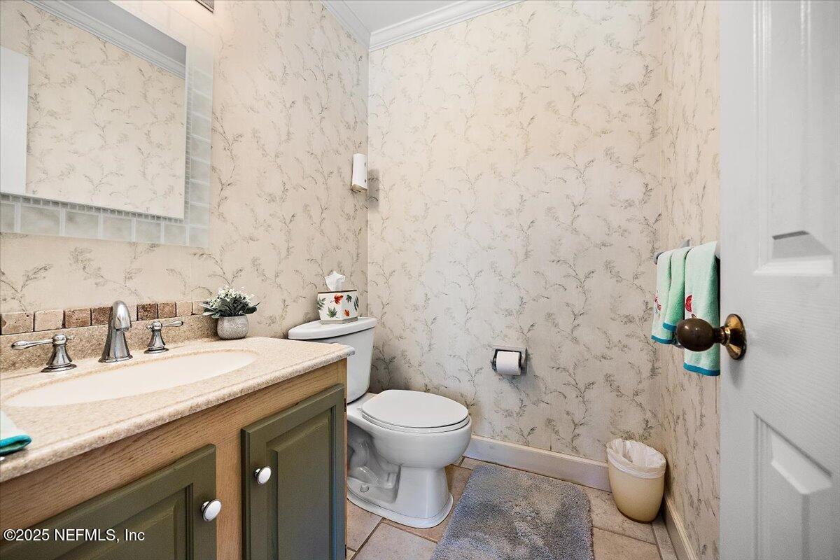 415 Bald Eagle Road Fleming Island, FL 32003 - Photo 11 of 27 a bathroom with a granite countertop sink toilet and a mirror