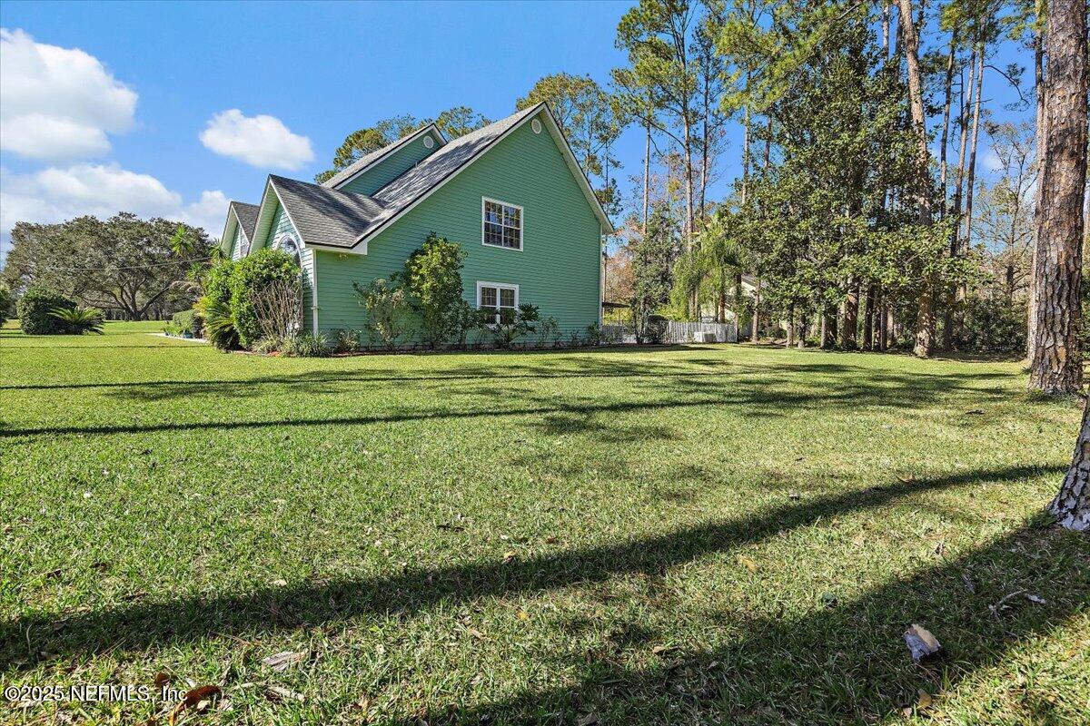 415 Bald Eagle Road Fleming Island, FL 32003 - Photo 26 of 27 a view of a golf course with a lake