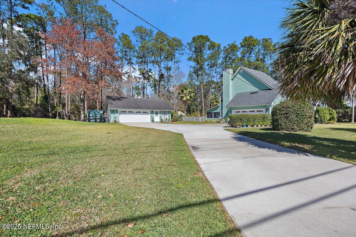 415 Bald Eagle Road Fleming Island, FL 32003 - Photo 3 of 27 a pathway of a house with a yard