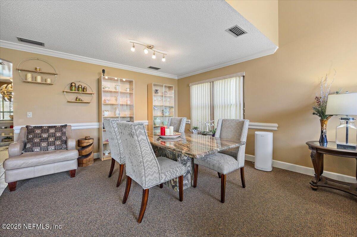 415 Bald Eagle Road Fleming Island, FL 32003 - Photo 6 of 27 a living room with furniture and a large window
