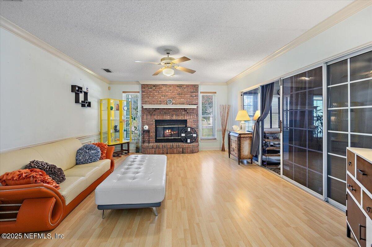 415 Bald Eagle Road Fleming Island, FL 32003 - Photo 9 of 27 a living room with furniture and a fireplace
