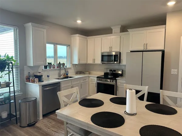a kitchen with a sink stove and refrigerator