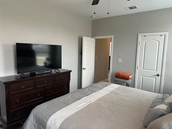 a bedroom with a bed and a flat screen tv