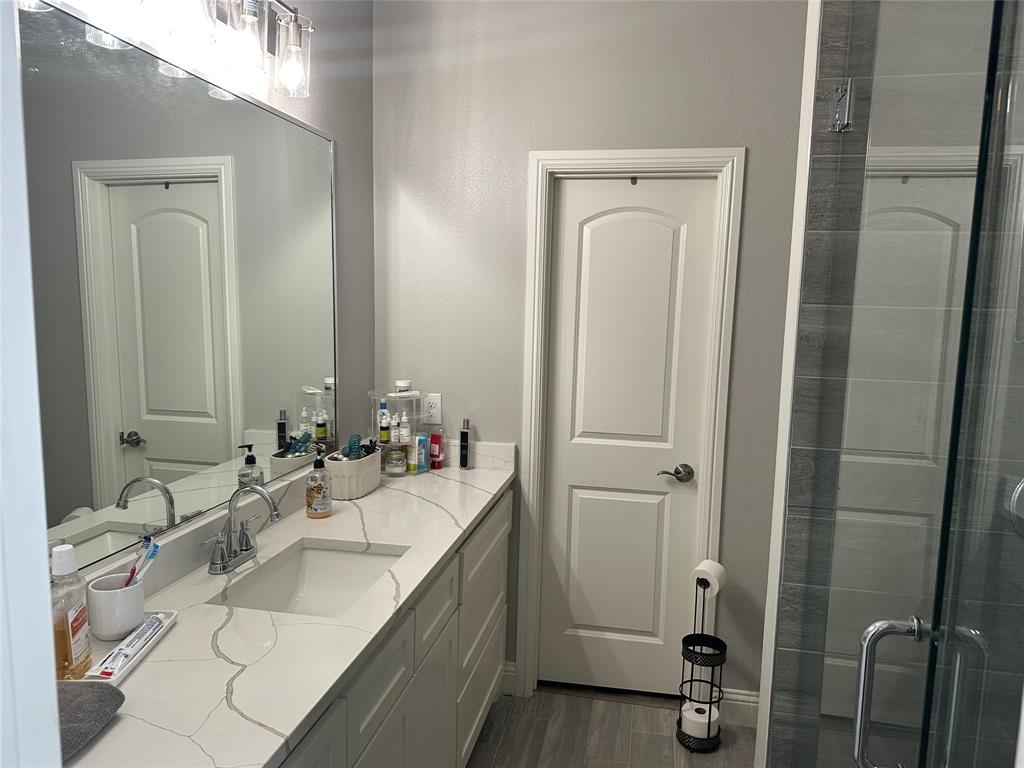 4760 County Road 4603 Commerce, TX 75428 - Photo 14 of 36 a bathroom with a double vanity sink mirror and double