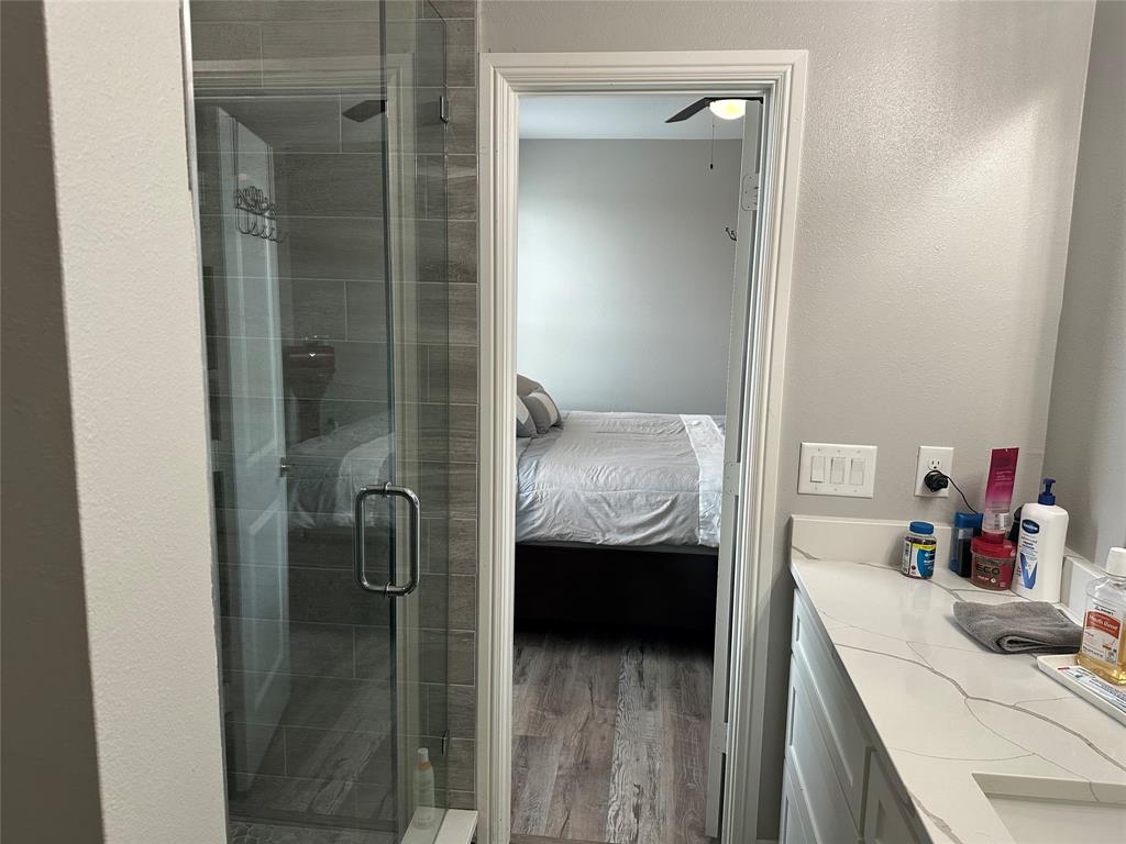 4760 County Road 4603 Commerce, TX 75428 - Photo 15 of 36 a bathroom with a sink and mirror