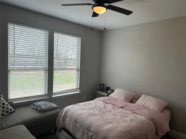 a bedroom with a bed and window