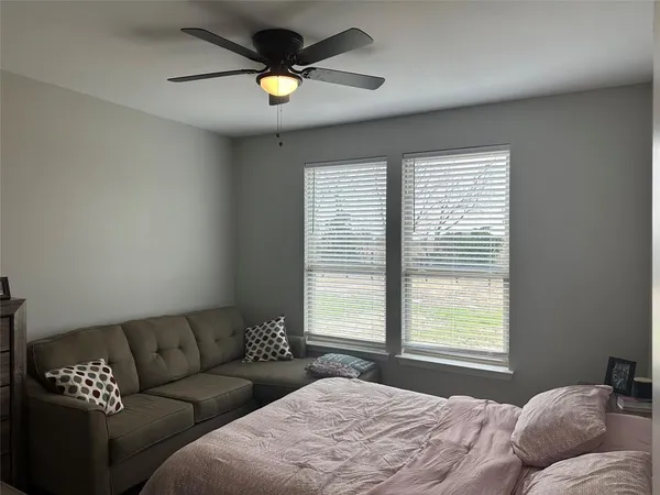 a bedroom with a large bed and a couch