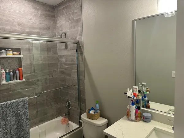 a bathroom with a sink a toilet and a shower
