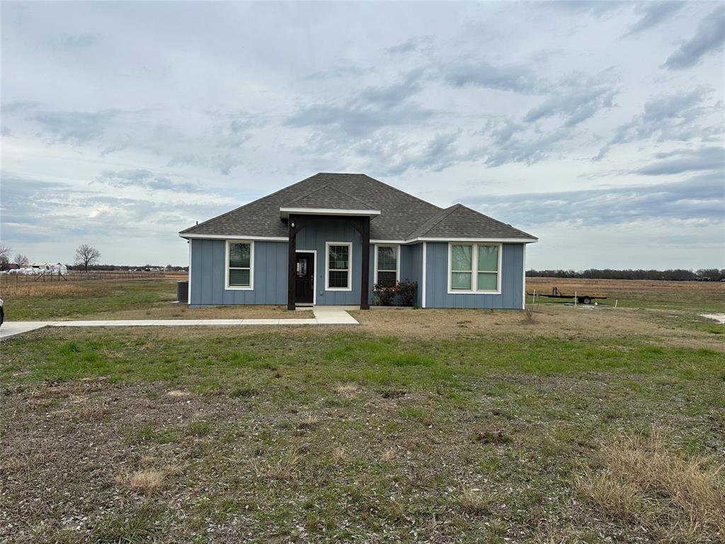 4760 County Road 4603 Commerce, TX 75428 - Photo 2 of 36 a front view of a house with a garden