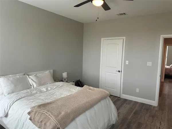a bedroom with a bed and a ceiling fan