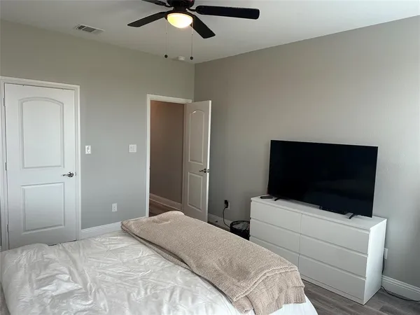 a bedroom with a bed and a flat screen tv