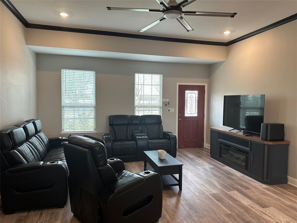 4760 County Road 4603 Commerce, TX 75428 - Photo 5 of 36 a living room with furniture and a flat screen tv
