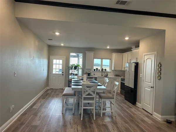 a view of a dining room with furniture window and wooden floor