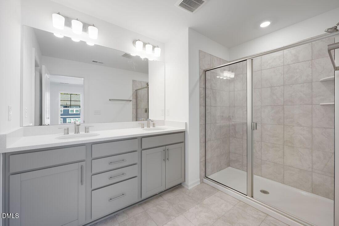 430 Rowe Way Knightdale, NC 27545 - Photo 19 of 51 a bathroom with a shower sink and mirror