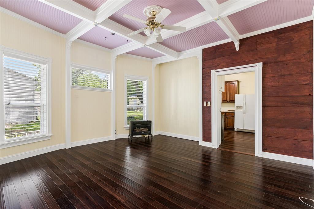 5824 Boone Street Sachse, TX 75048 - Photo 9 of 40 a view of an empty room with wooden floor and a window