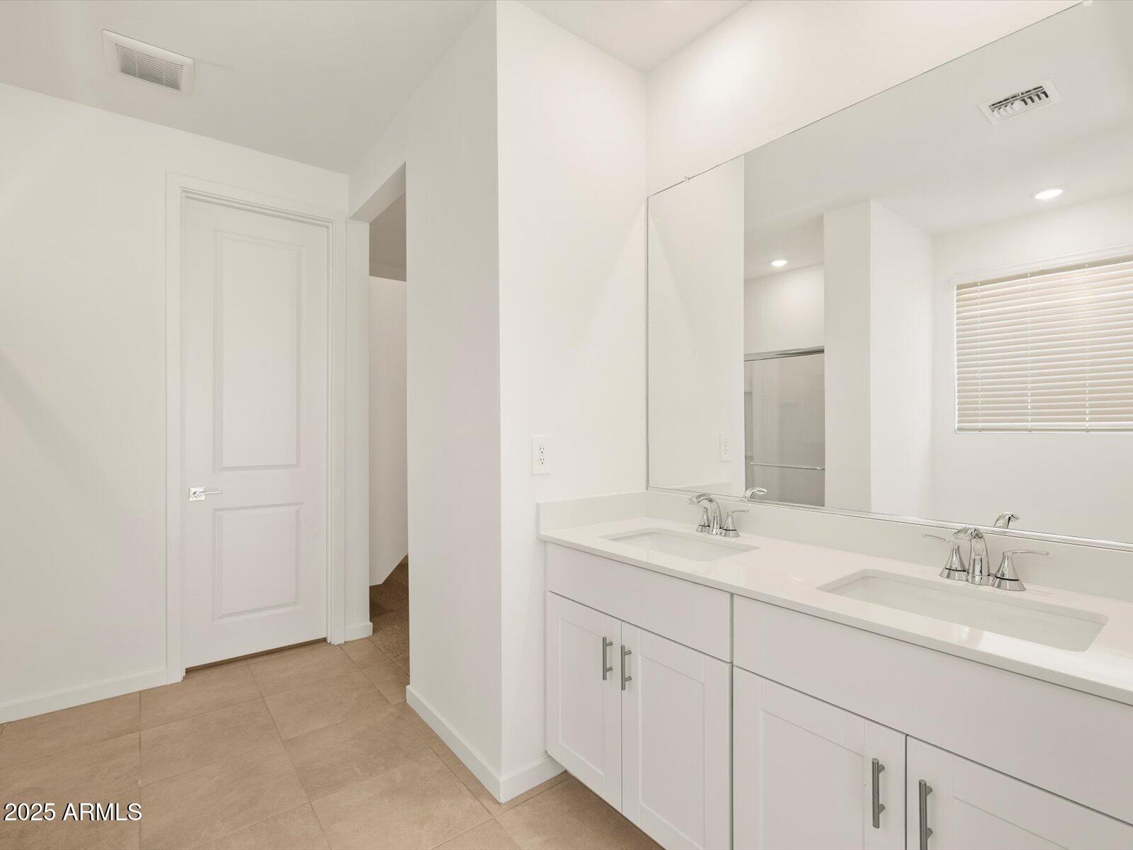 2426 Grenache Road San Tan Valley, AZ 85143 - Photo 15 of 73 a bathroom with 2 sink and a mirror