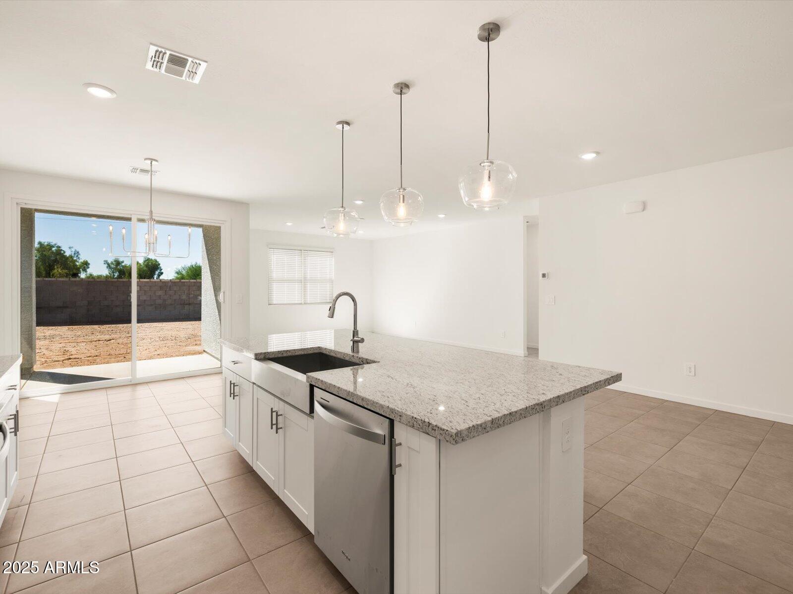 2426 Grenache Road San Tan Valley, AZ 85143 - Photo 9 of 73 a kitchen with stainless steel appliances granite countertop a sink a counter top space and cabinets