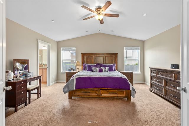 a spacious bedroom with a bed and furniture