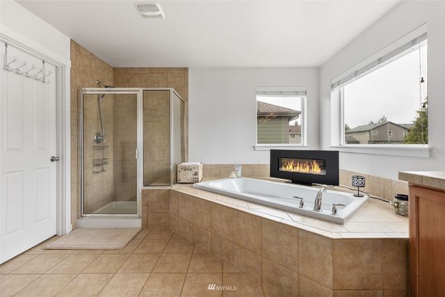 a living room with a fireplace furniture and a large window