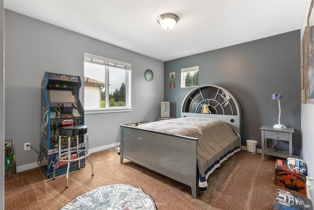 a bedroom with a bed a table and chair