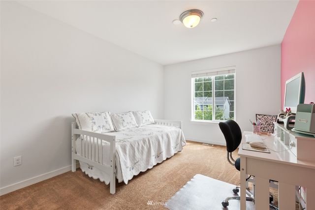 a bedroom with a bed lamp and a window