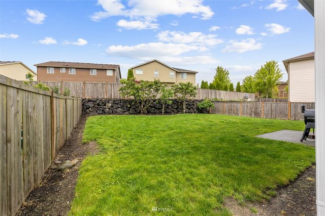 a view of a house with a yard and garden