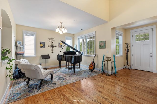 a living room with furniture a wooden floor and a chandelier