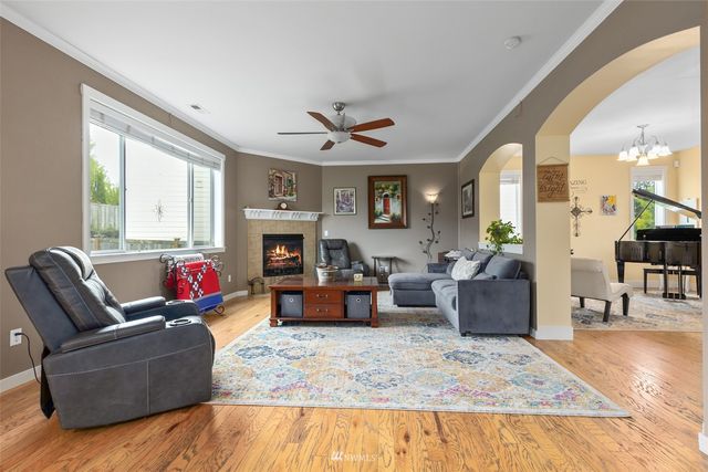 a living room with furniture kitchen view and a fireplace