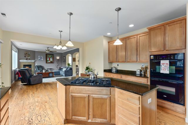 a kitchen with stove refrigerator and cabinets