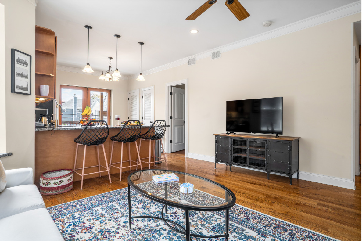 2117 West Irving Park Road, Unit 2R Chicago, IL 60618 - Photo 12 of 16 a living room with furniture and a flat screen tv