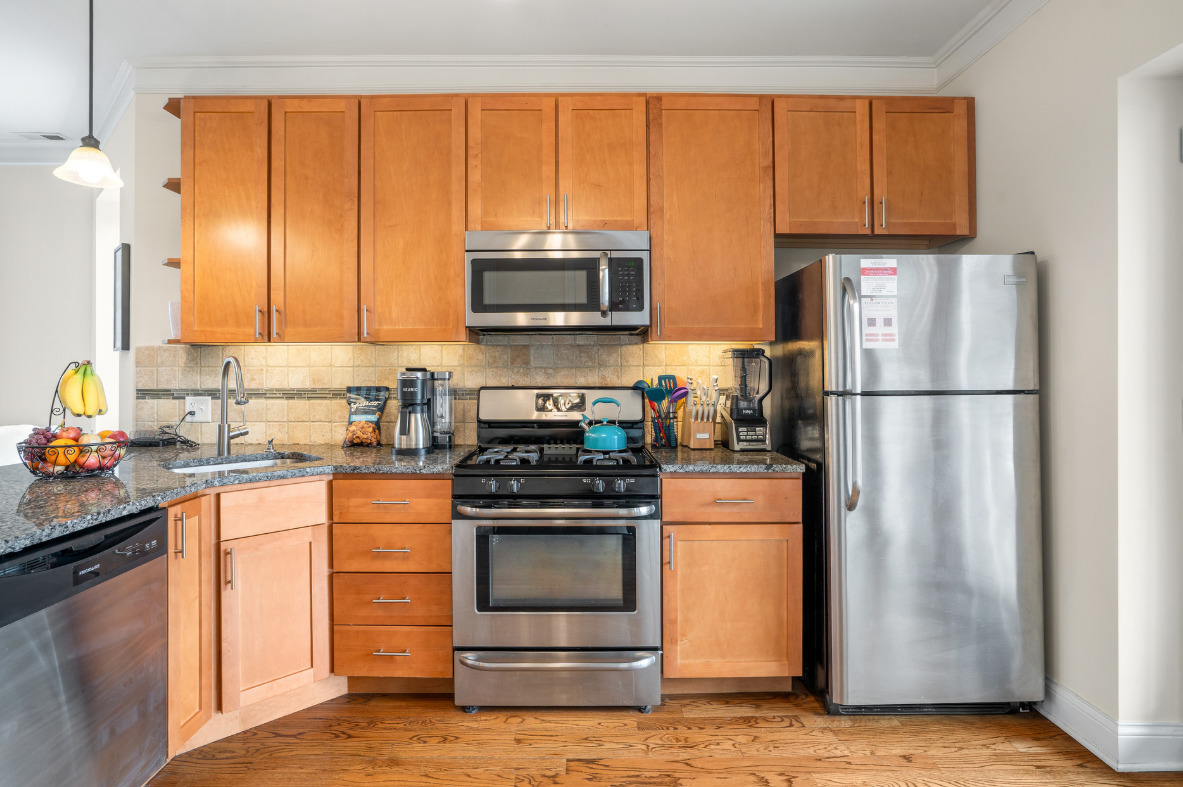 2117 West Irving Park Road, Unit 2R Chicago, IL 60618 - Photo 3 of 16 a kitchen with a refrigerator stove and microwave