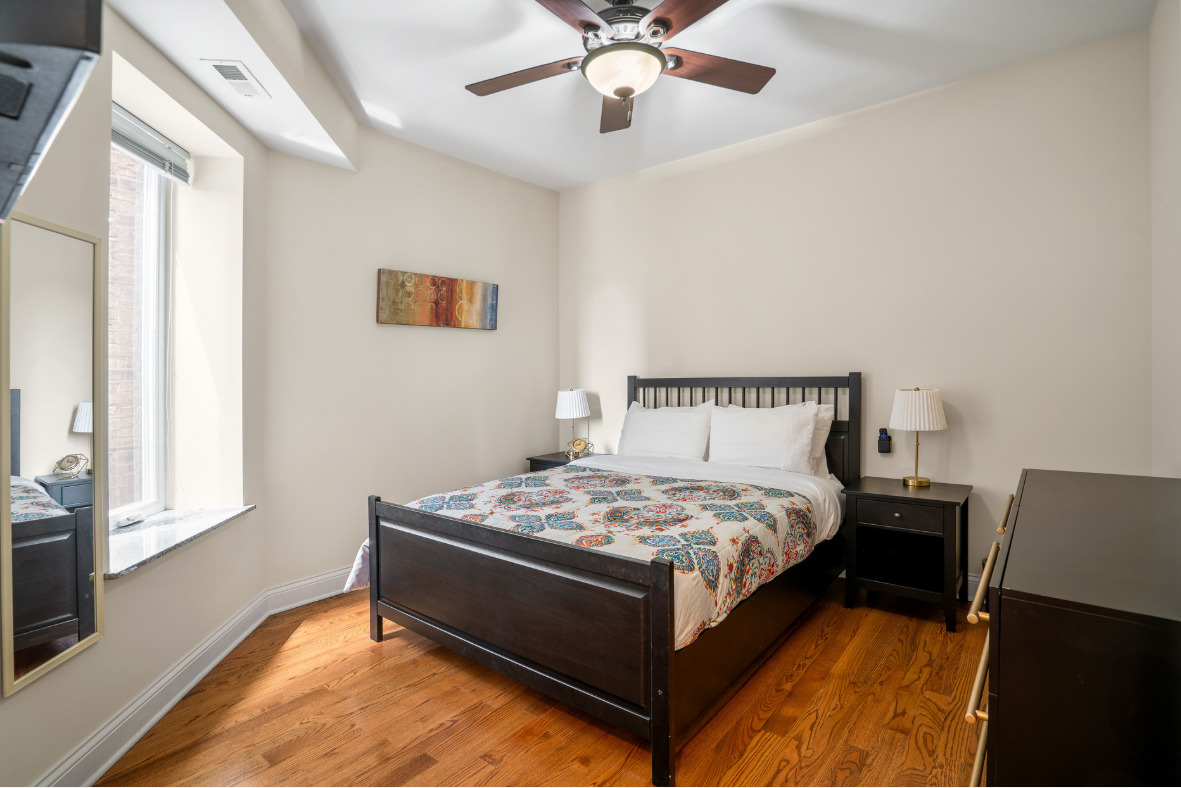 2117 West Irving Park Road, Unit 2R Chicago, IL 60618 - Photo 5 of 16 a bedroom with a bed and window
