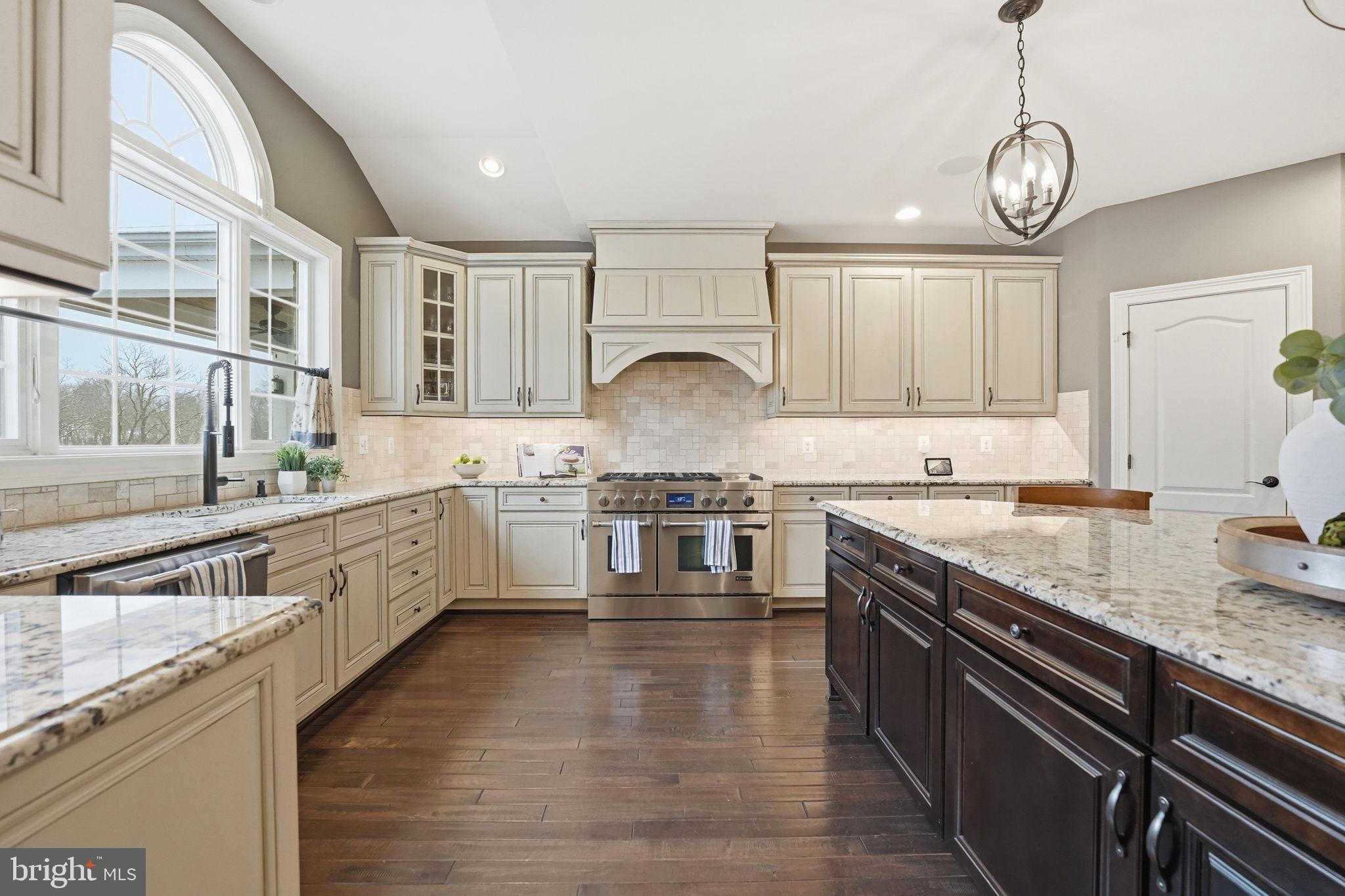 17972 Running Colt Place Leesburg, VA 20175 - Photo 19 of 99 a kitchen with stainless steel appliances granite countertop a stove a sink and white cabinets
