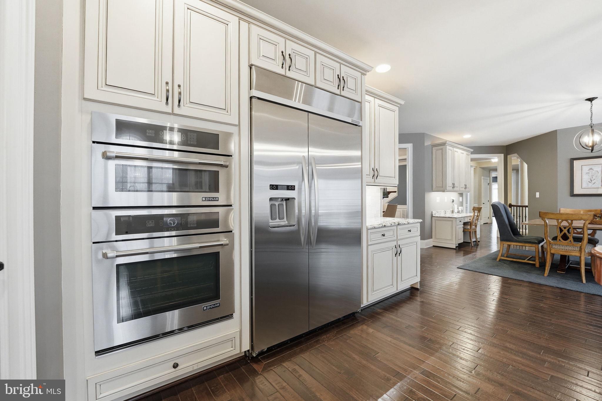 17972 Running Colt Place Leesburg, VA 20175 - Photo 24 of 99 a kitchen with stainless steel appliances and wooden floor