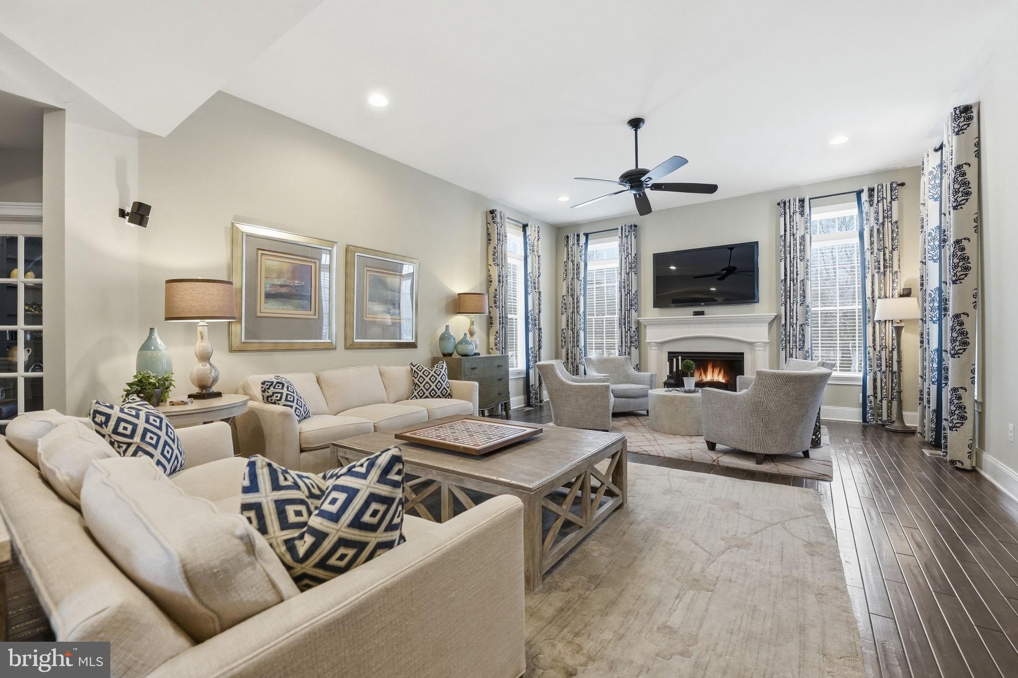 17972 Running Colt Place Leesburg, VA 20175 - Photo 29 of 99 a living room with furniture a fireplace and a flat screen tv