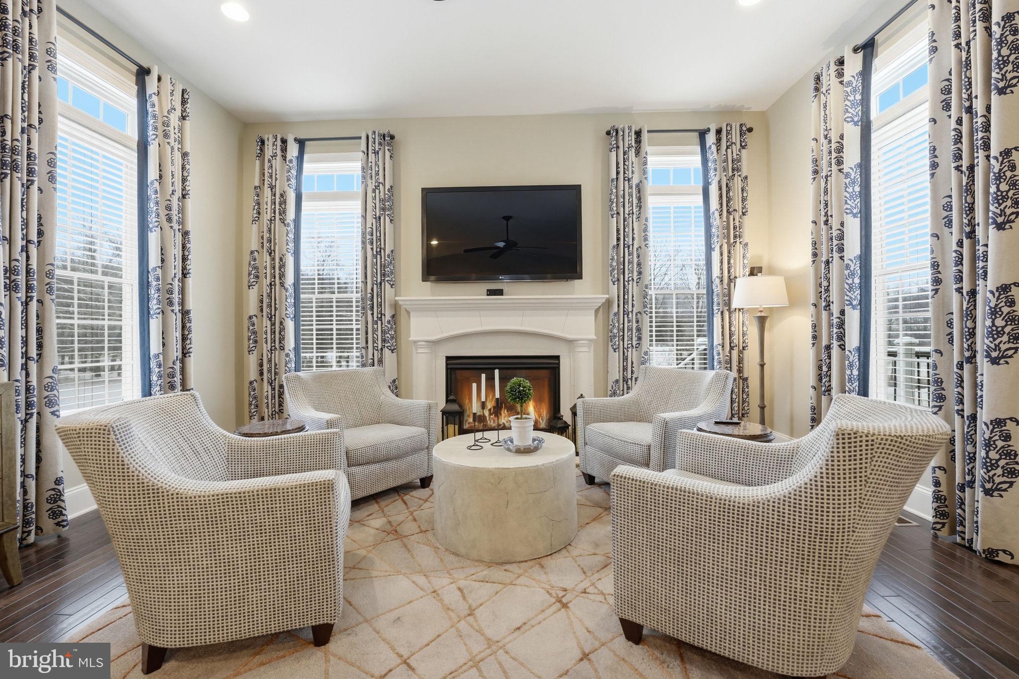 17972 Running Colt Place Leesburg, VA 20175 - Photo 31 of 99 a living room with furniture fireplace and flat screen tv