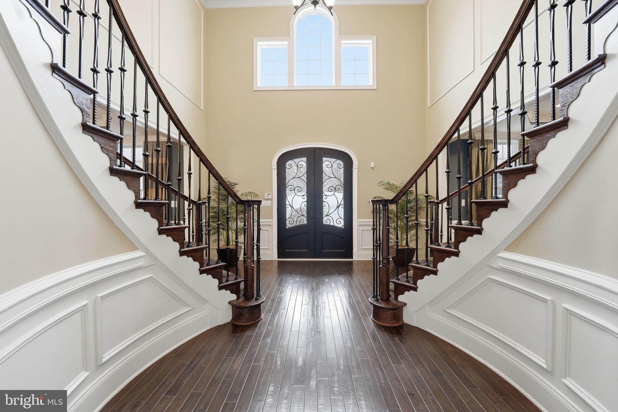 17972 Running Colt Place Leesburg, VA 20175 - Photo 40 of 99 a view of staircase with wooden floor and a large window