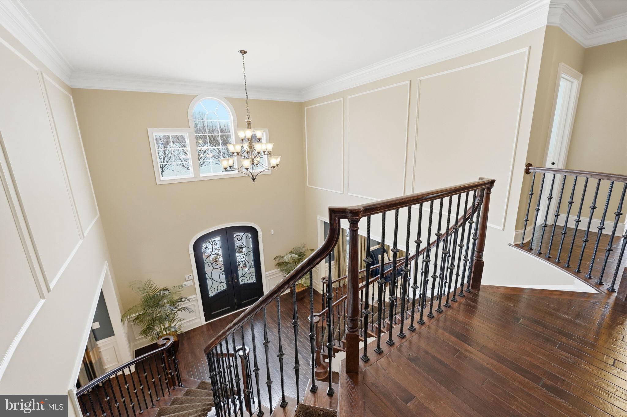 17972 Running Colt Place Leesburg, VA 20175 - Photo 41 of 99 a view of a hallway with wooden floor and stairs