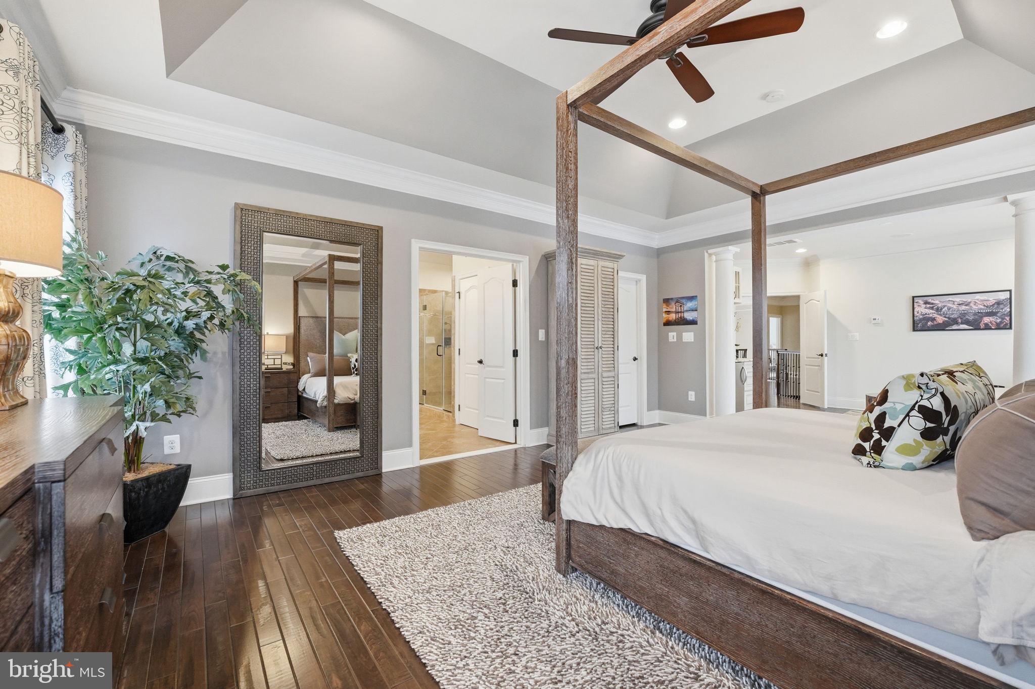 17972 Running Colt Place Leesburg, VA 20175 - Photo 48 of 99 a bedroom with a large bed and wooden floor