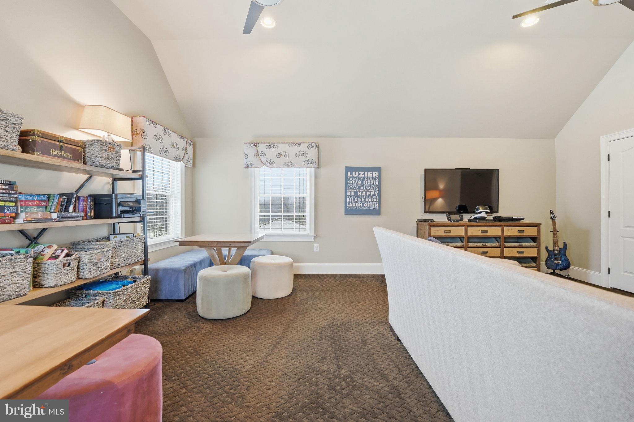 17972 Running Colt Place Leesburg, VA 20175 - Photo 58 of 99 a living room with furniture and a flat screen tv